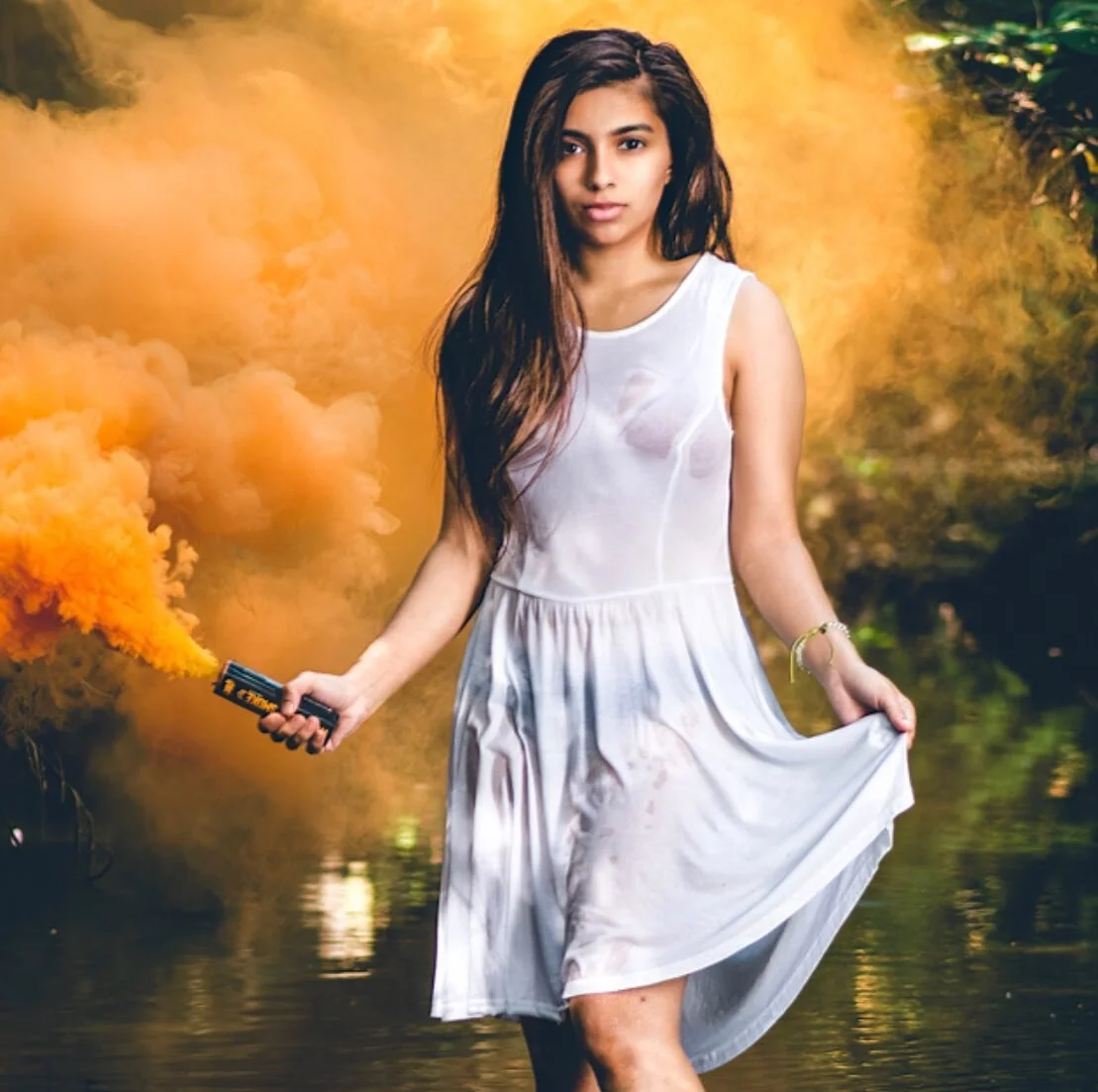 &lsquo;Orange smoke&rsquo; is the most original caption I could think of &hellip; with Mina .. 
.
.
.
#model , #modelling ,#smoke , #smokebomb, #river , #tfitsfriday , #whitedress , #wetmodel , #orangesmoke
