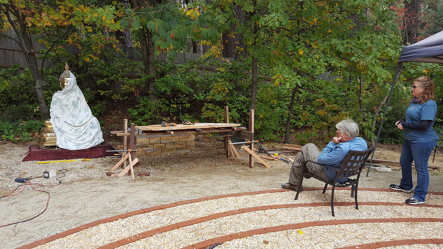 Rick and Ann consider how to move the 500 lb Buddha a few feet over to the pedastal