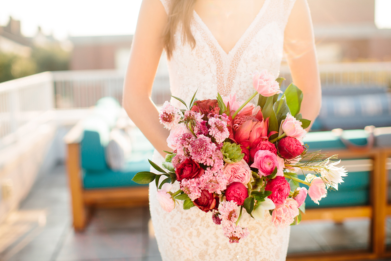 Summer wedding bouquet filled with pinks and deep reds.