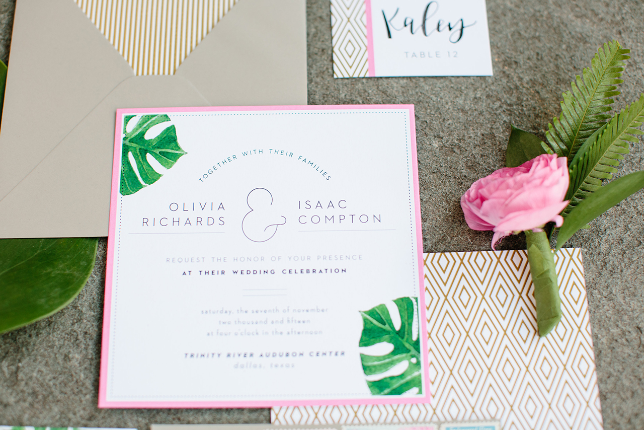 The invitation suite featured watercolored leaves along with pops of hot pink and gold. 