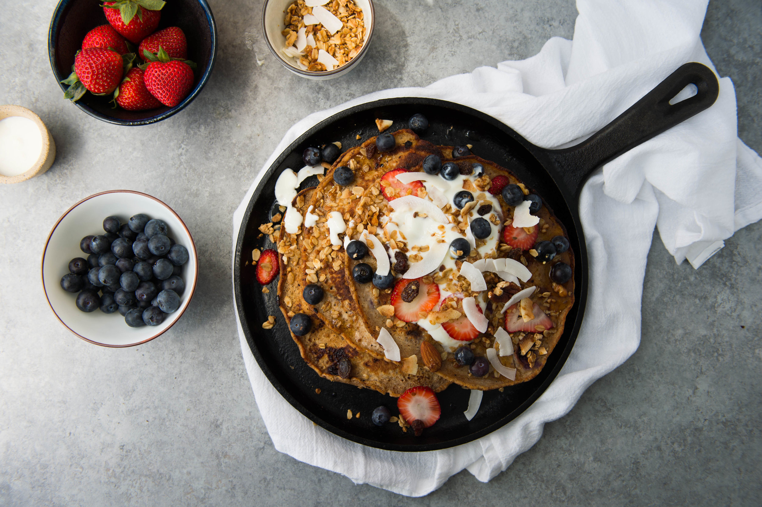Skillet quinoa and buttermilk berry pancakes with shaved coconut