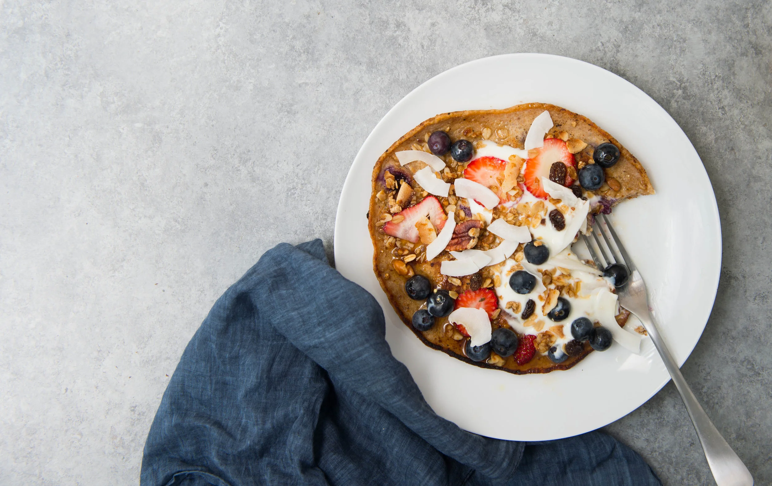 Skillet quinoa and buttermilk berry pancakes with shaved coconut