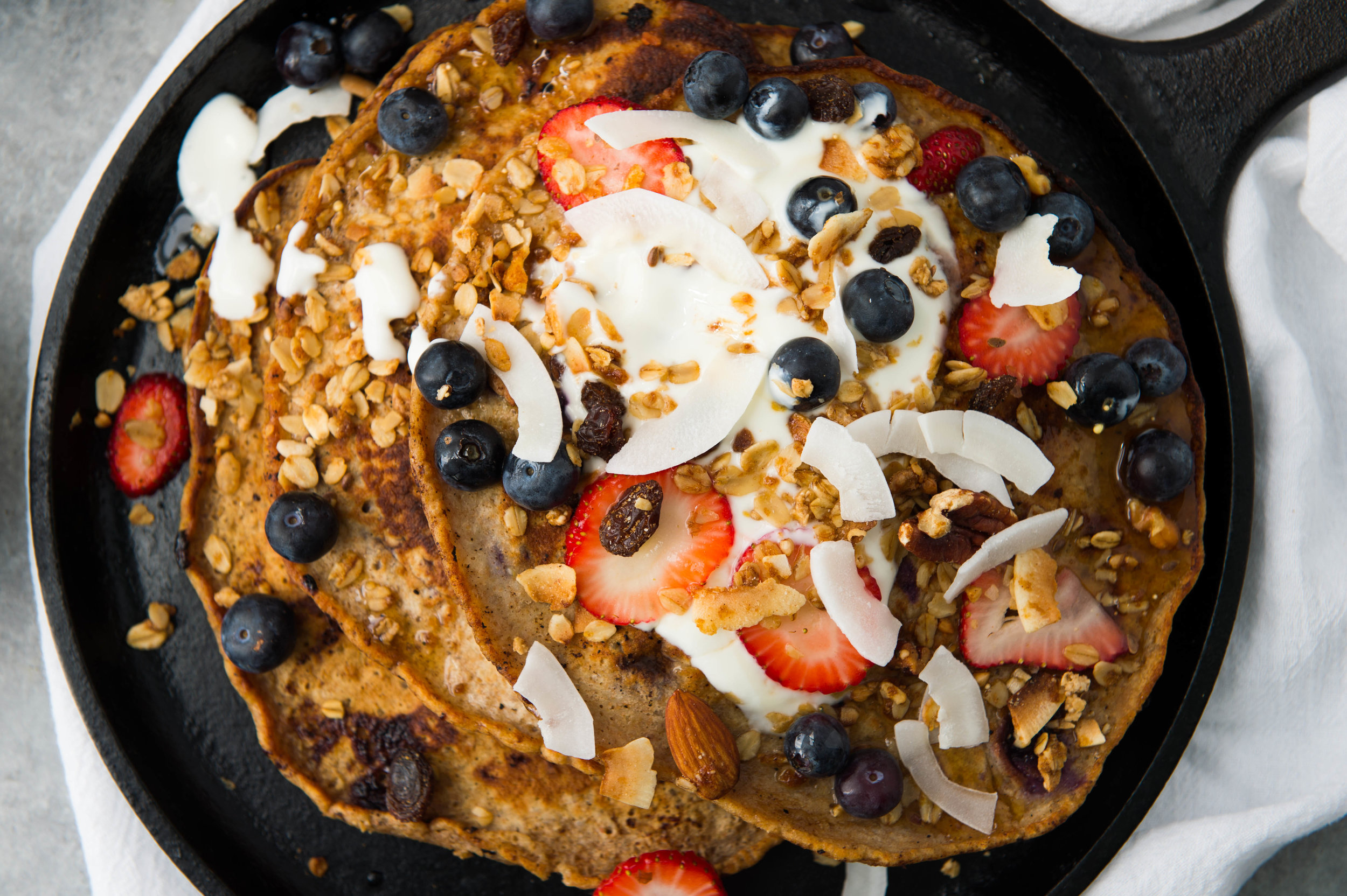 Skillet quinoa and buttermilk berry pancakes with shaved coconut
