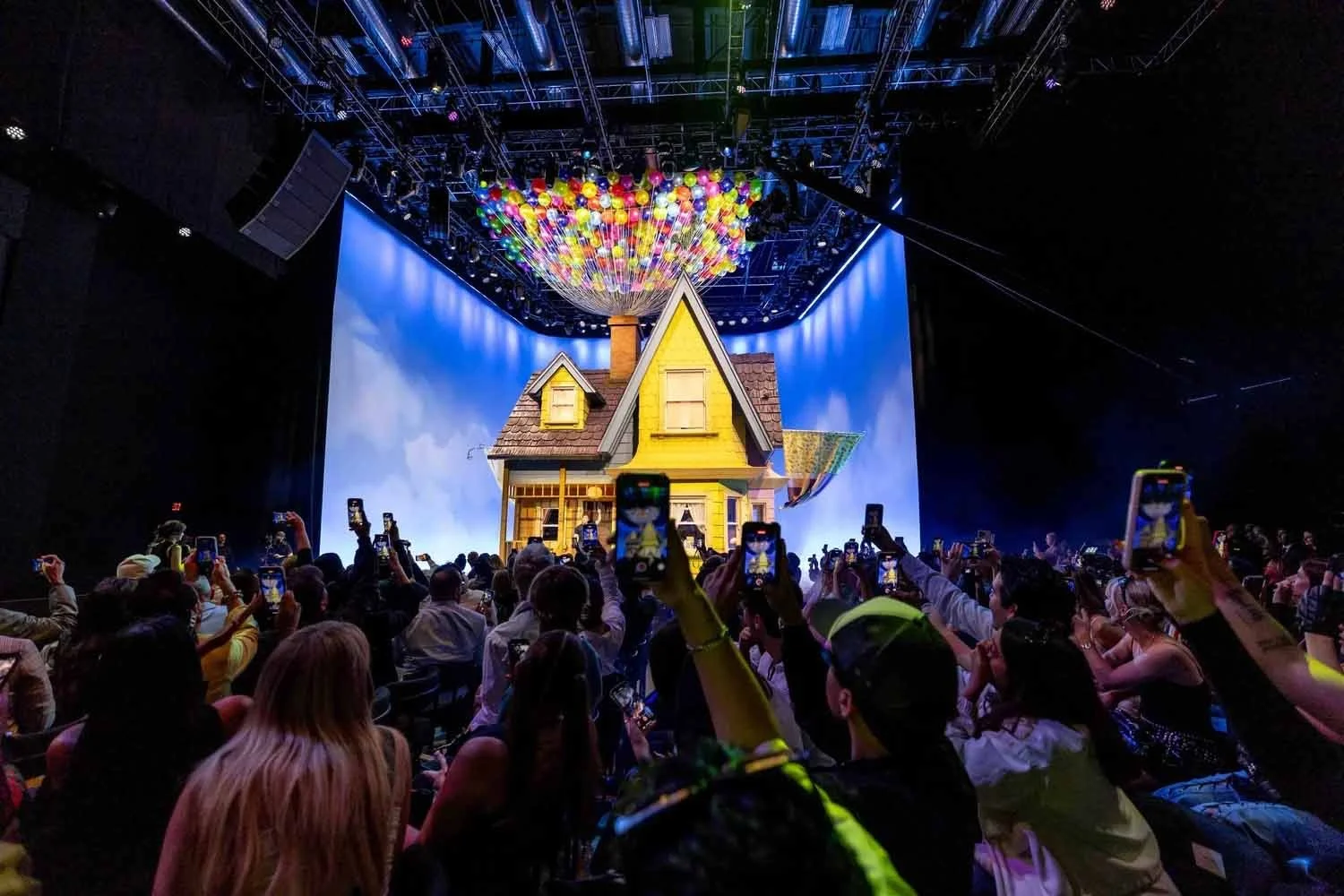 Attendees photographing a life-size replica of the house from Pixar's Up at an Airbnb Icons launch event in Los Angeles.