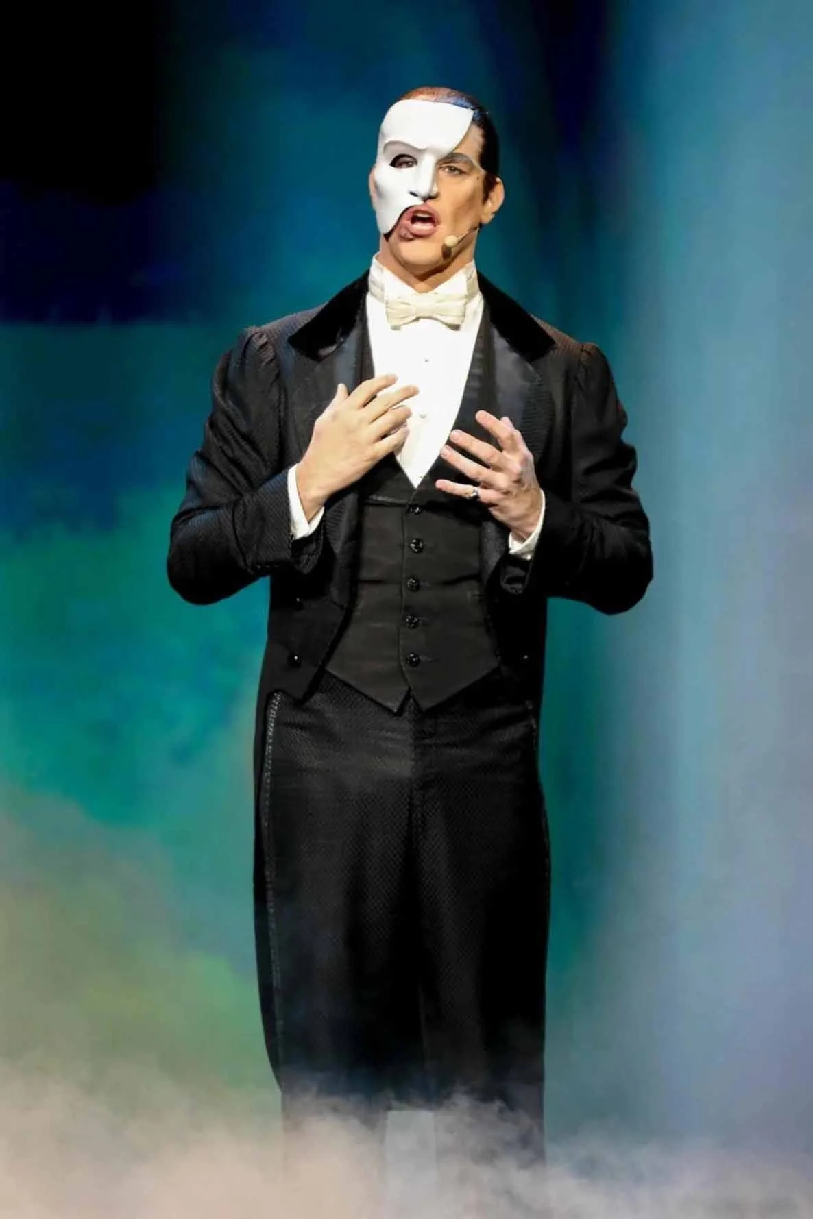 A live stage performance of Andrew Lloyd Webber's The Phantom of the Opera featuring the iconic chandelier during the 'Masquerade' sequence at the Hollywood Pantages Theatre.