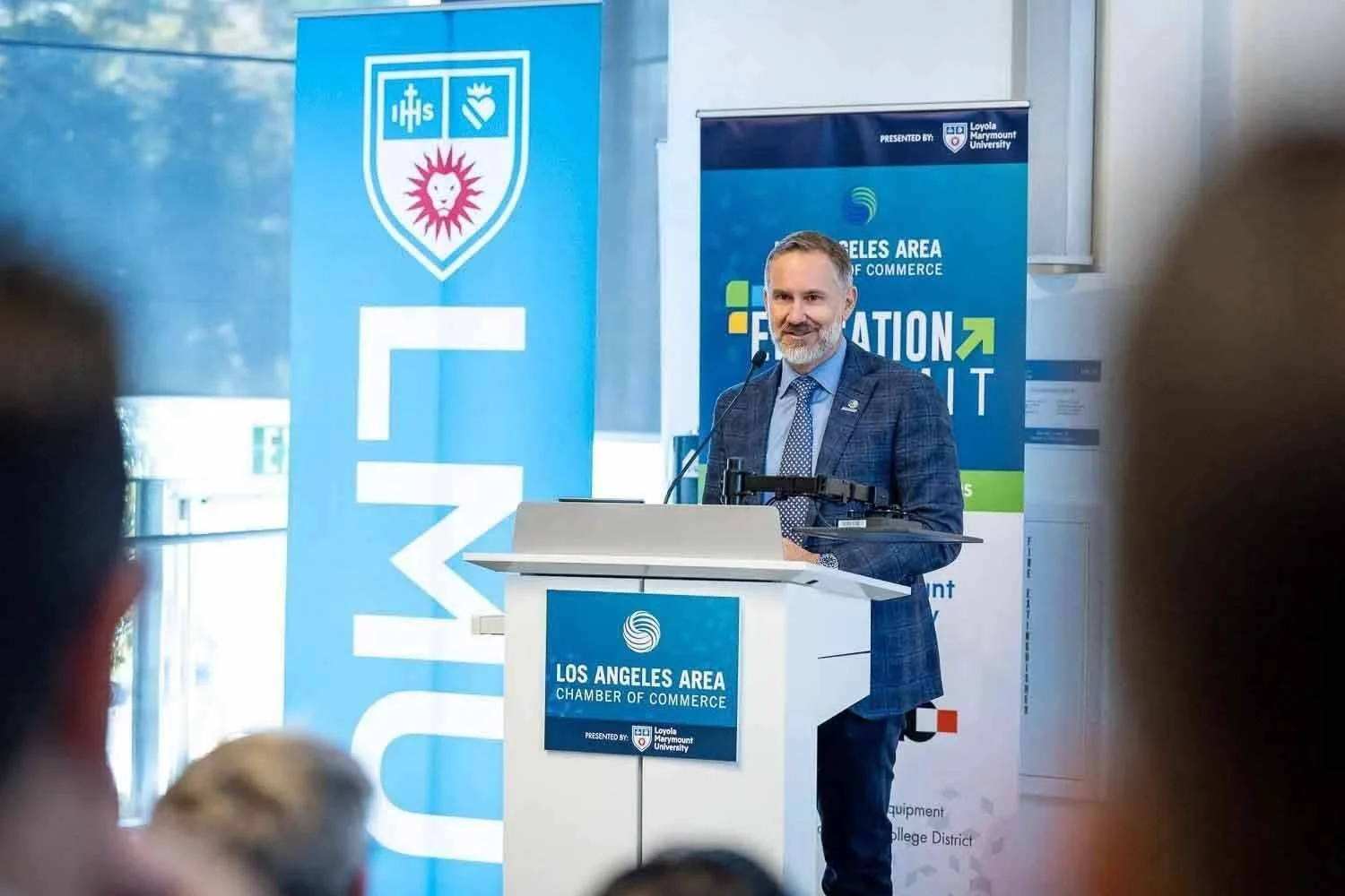 A representative from the LA Chargers organization speaking at a Los Angeles Area Chamber of Commerce business event.