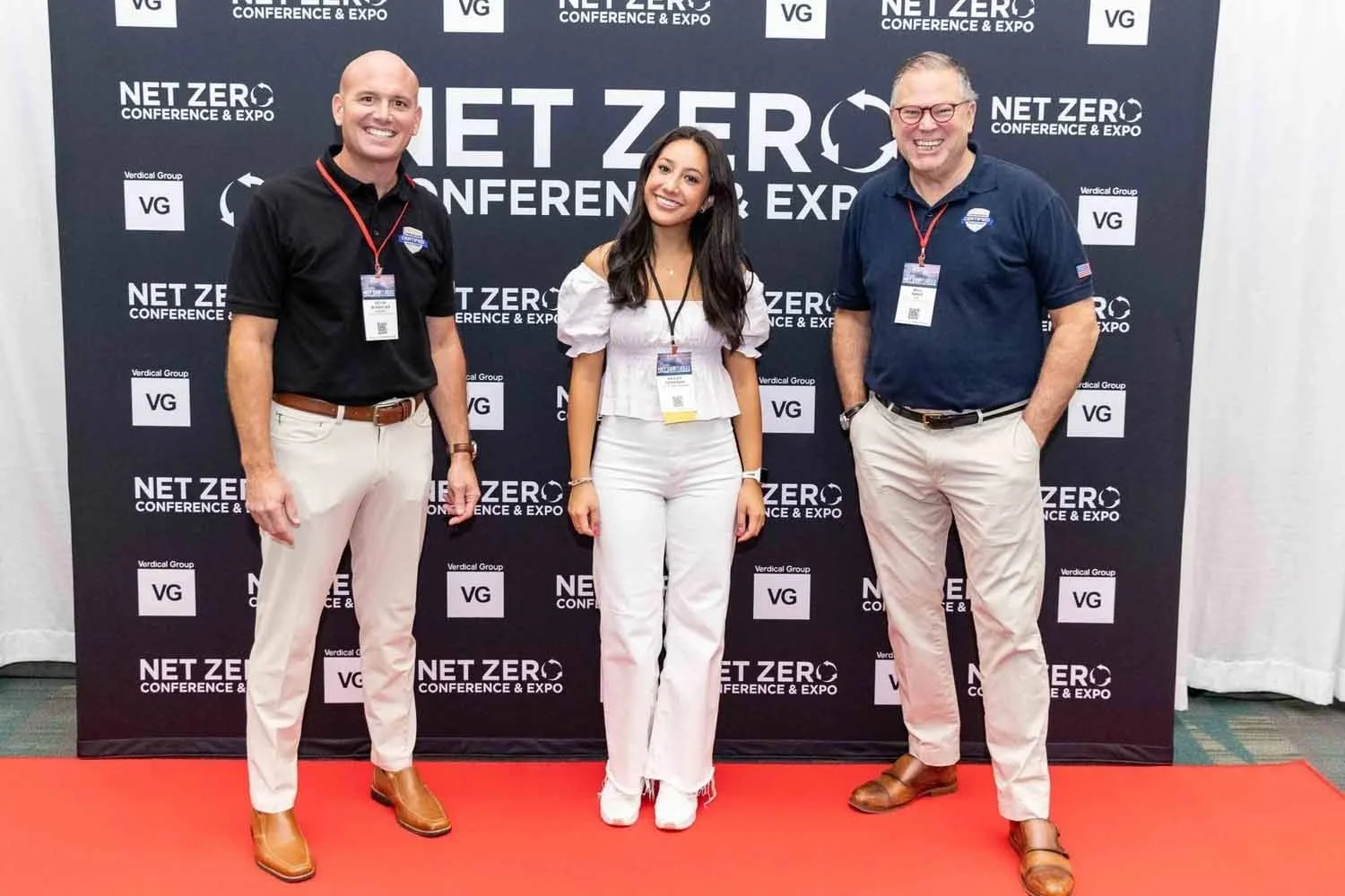 A group of sustainability leaders posing on the red carpet at the Net Zero Conference hosted by Verdical Group at the Los Angeles Convention Center.