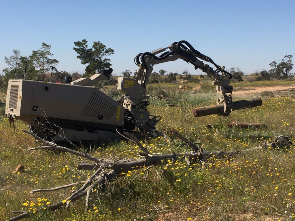 GCS-100 with the robotic arm attachment handling a large unexploded ordnance