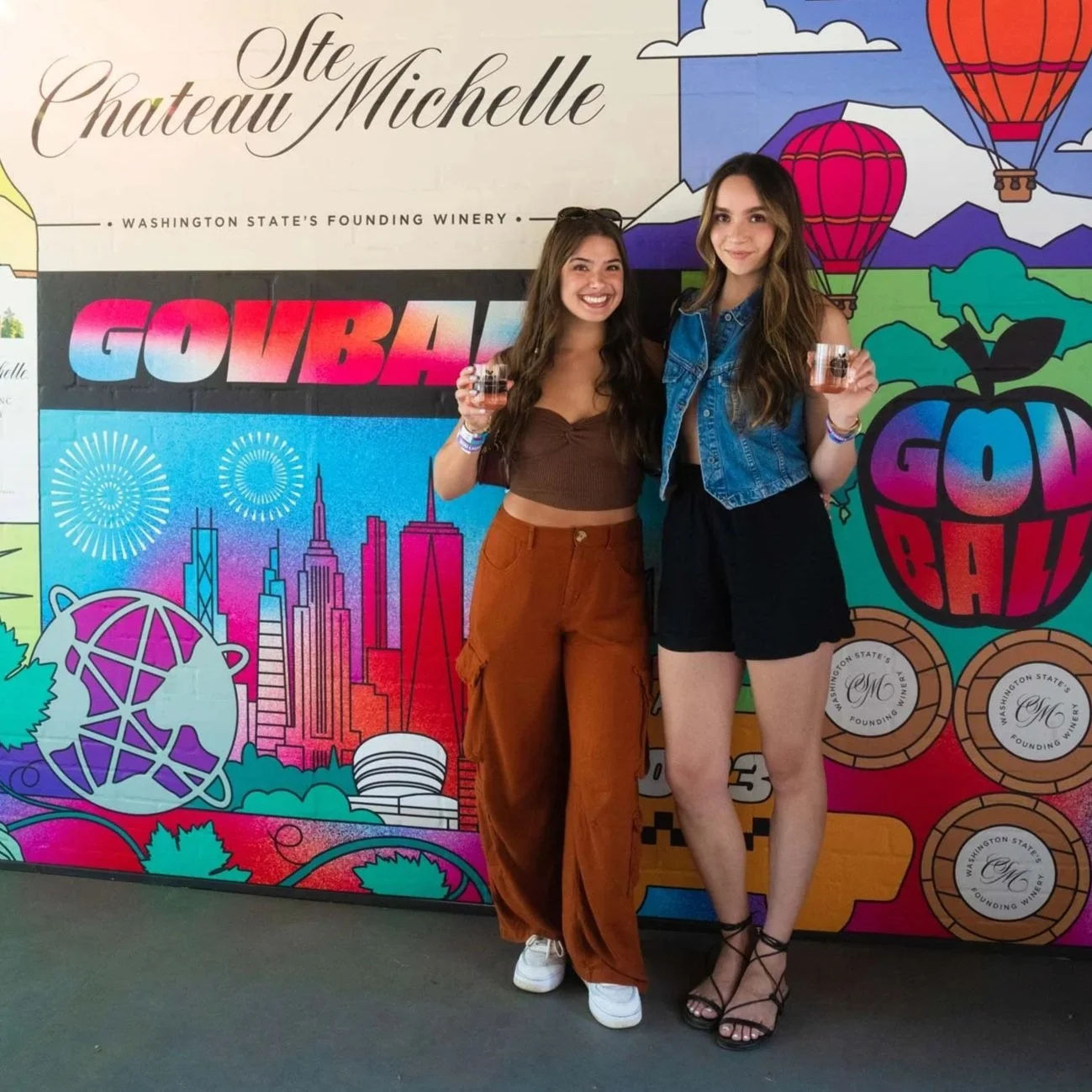 Photograph of festival-goers posing for a photograph in front of my Chateau Ste Michelle illustrated photo-wall mural at Govball festival in New York, USA