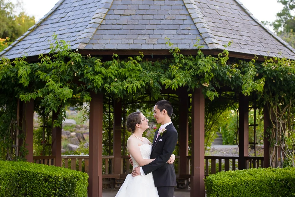 Bride and groom under gazebo