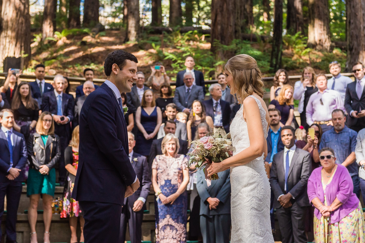 Bride and groom smiling at the altar
