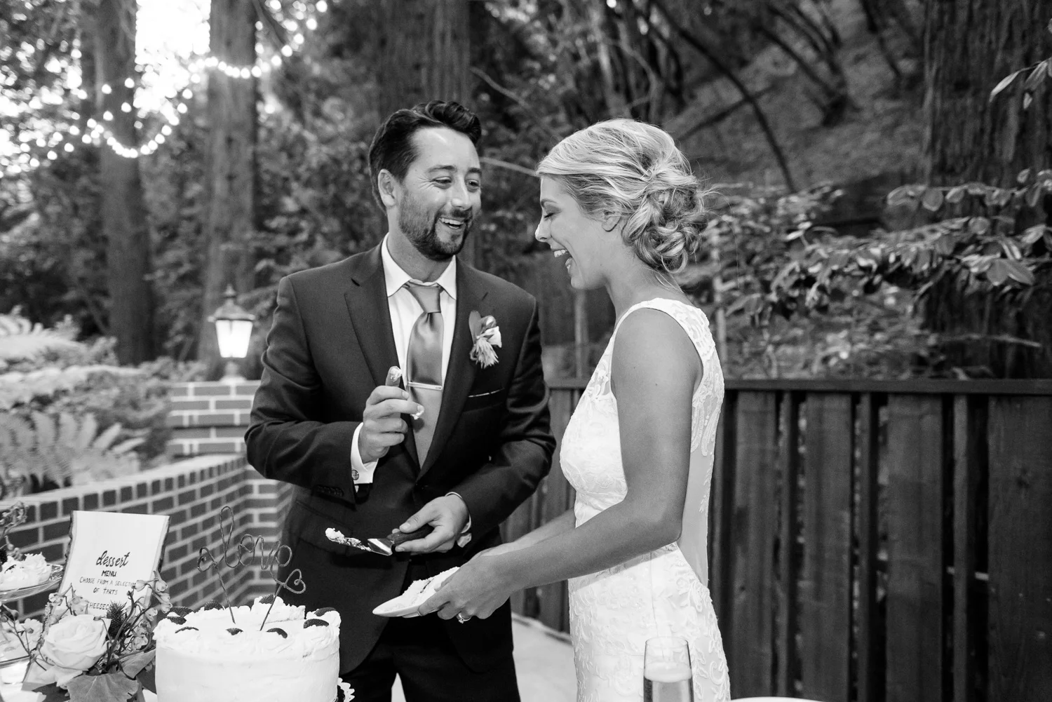 Groom putting cake on bride's nose