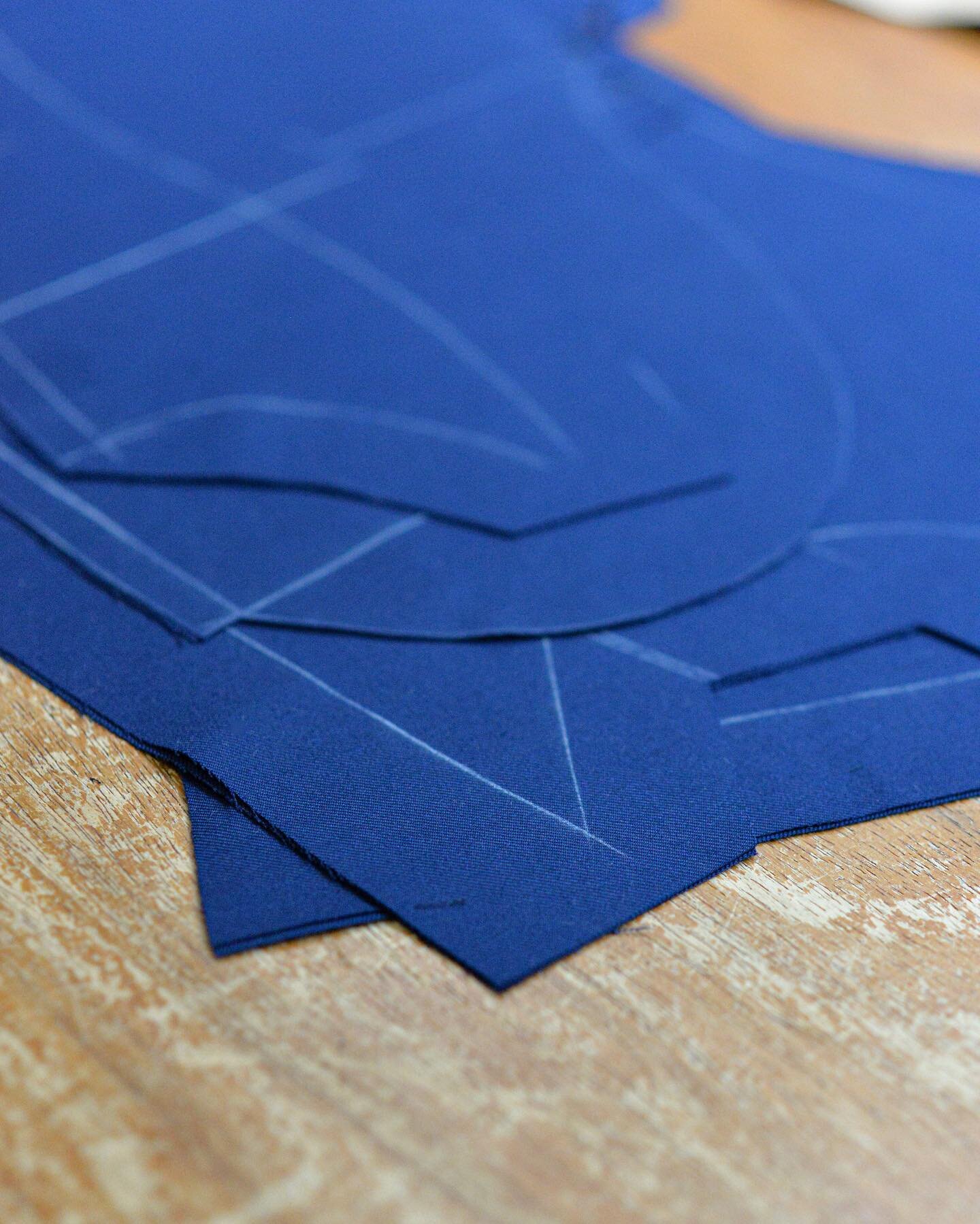 A vibrant blue wool cloth , cut and ready to be made into a fitting .