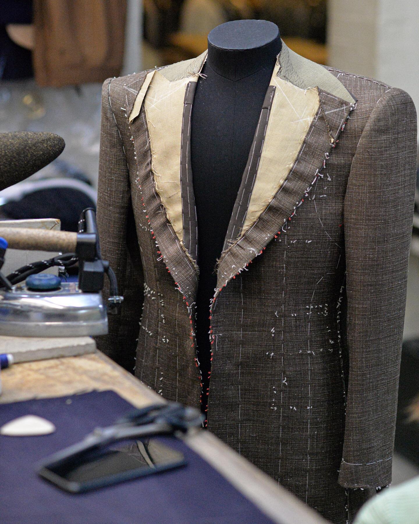 A summer jacket ready for fitting in the workshop. All our clothes go through a series of fittings , being re cut, re basted and tried on again until both the client and ourselves are happy with every line and detail , before being moved forward to t