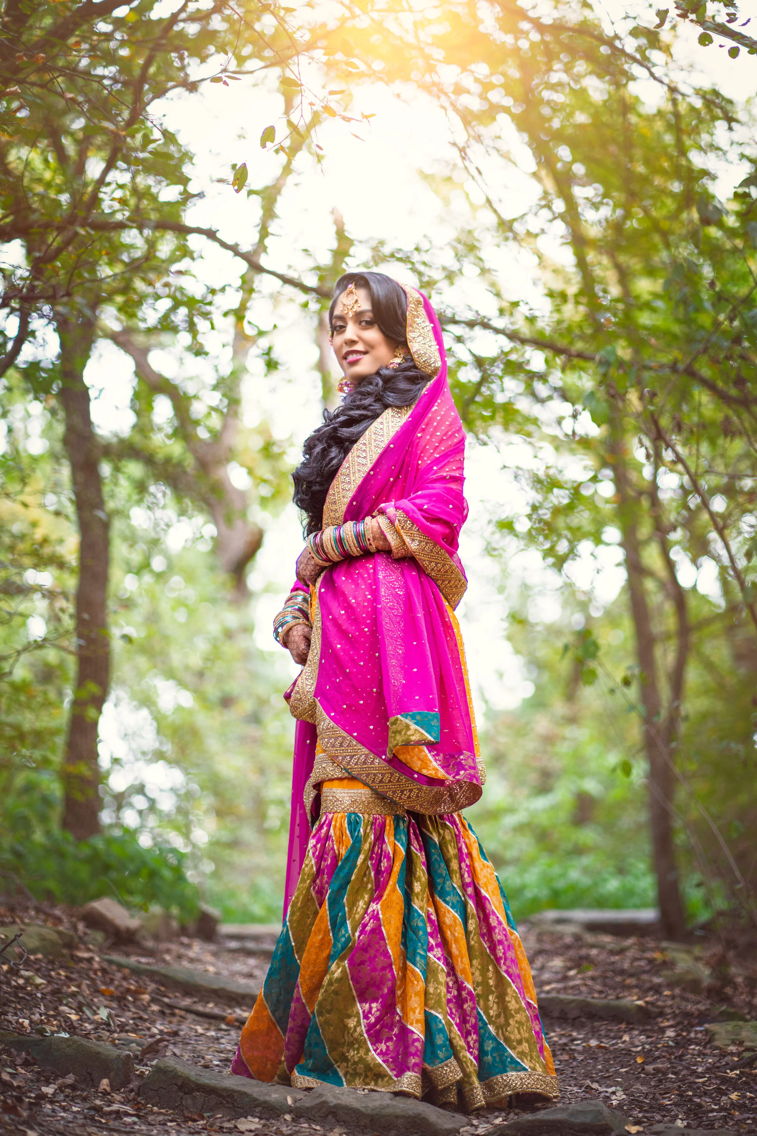 Woman in traditional Indian clothing standing in a forest