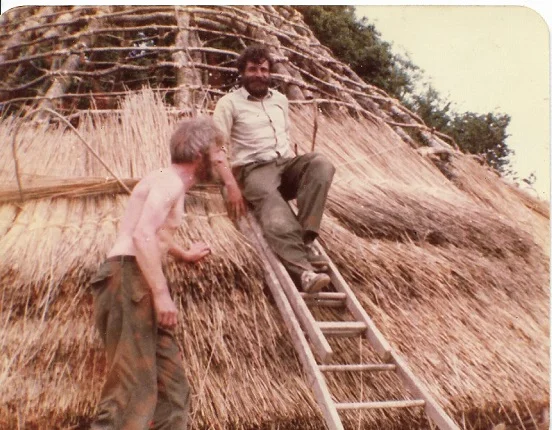 Steve and Howell, thatching the first roundhouse at Castell Henllys 1981, using Welsh reed