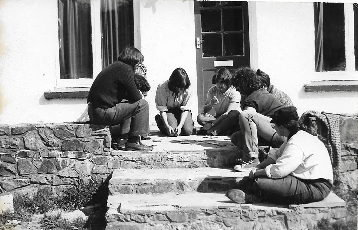 Playing cards in front of the farmhouse at Castell Henllys, Easter 1981. Director Harold far left; Supervisor Lisa far right.
