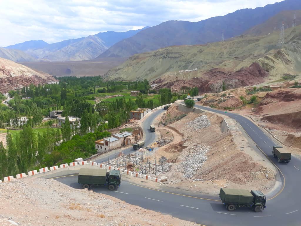 army trucks making their way downwards on the leh to srinagar highway while we scramble upwards