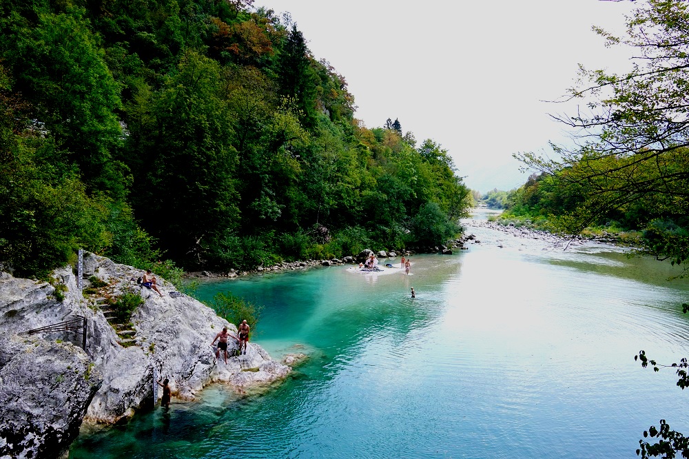 Diving into the deep blue-green waters in Soca Valley, Slovenia