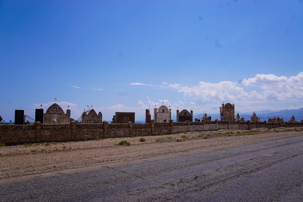 Domes and minarets visible on these cemeteries while cycling through Balykchy