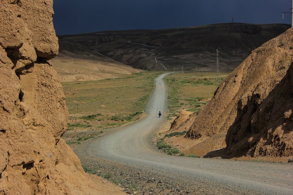 Slowly rolling in from afar and a looming storm behind me, the unpredictability of bicycle touring in Central Asia. PC: Joanna