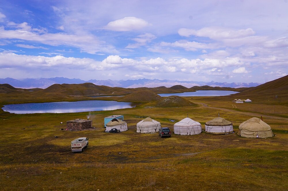 Tulpar-Kol Lake glistens in the afternoon sun next to the CBT yurts.