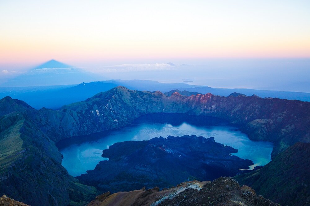 clearly beautiful to see the the turquoise Segara Anak crater lake, with the conical shape of Gunung Baru volcano protruding from its waters at mount rinjani.