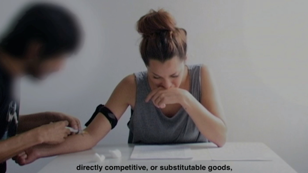 Daniela Ortiz: FDTD (Forcible Drugging To Deport) (2012/2016) Video installation with video (6 min.) props (syringe and ampoule) & documents (“Code of Conduct for joint return operations coordinated by Frontex” and “Guide for Joint Return Operations by Air coordinated by Frontex”). Courtesy the artist