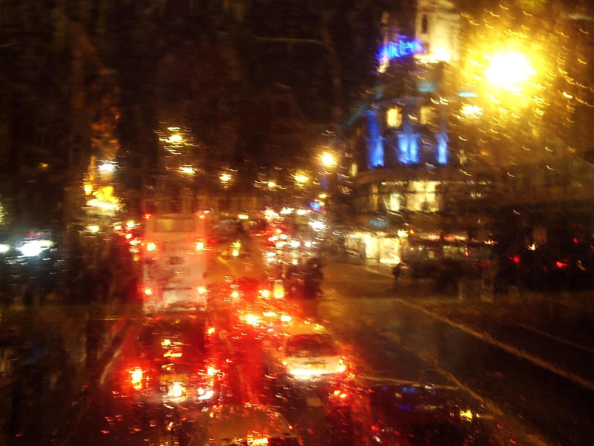 Rain on double decker bus window, London.