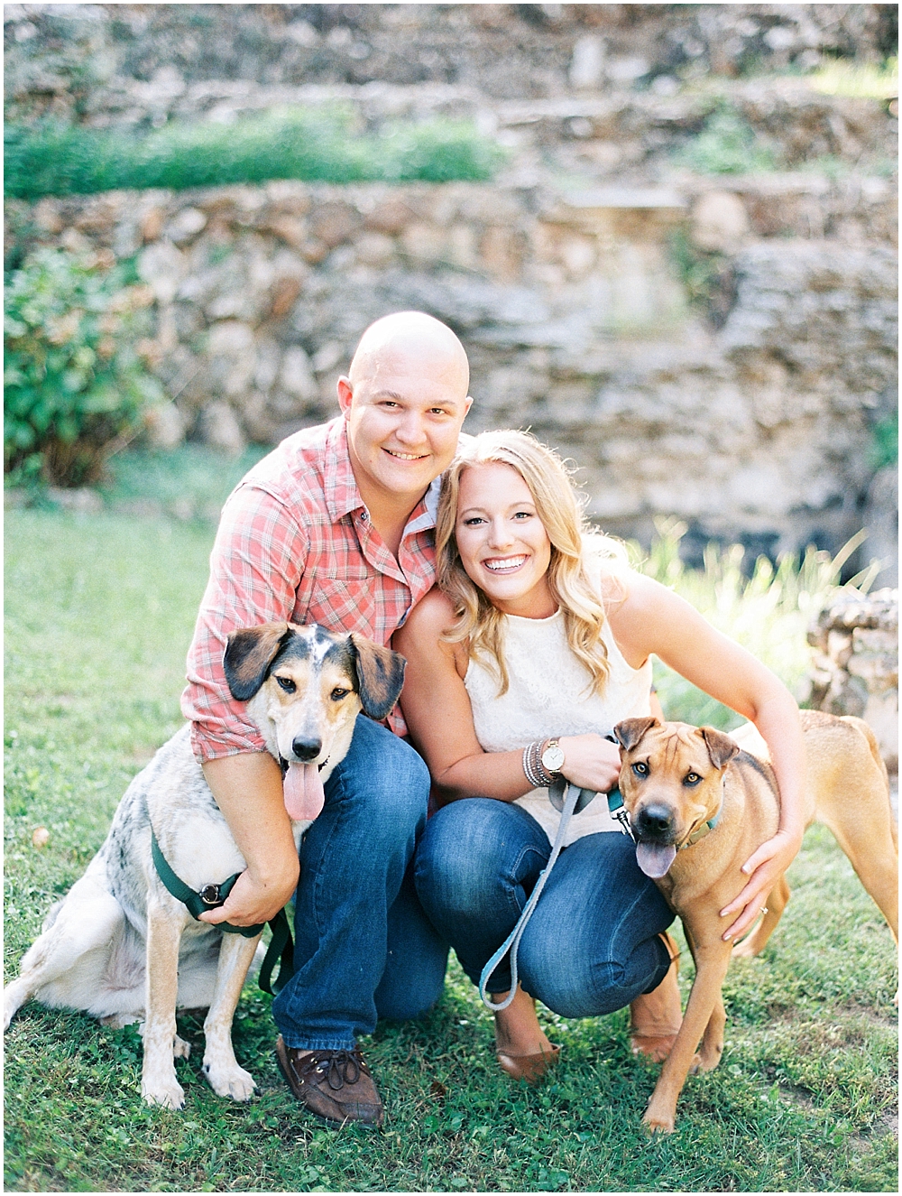 Happy engaged couple with dogs
