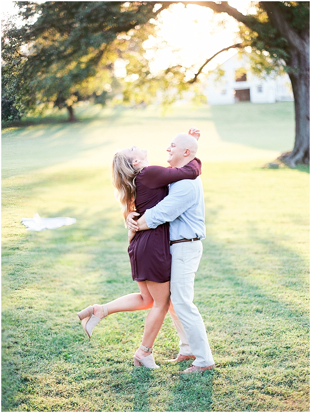 Happy couple spins around during engagement session