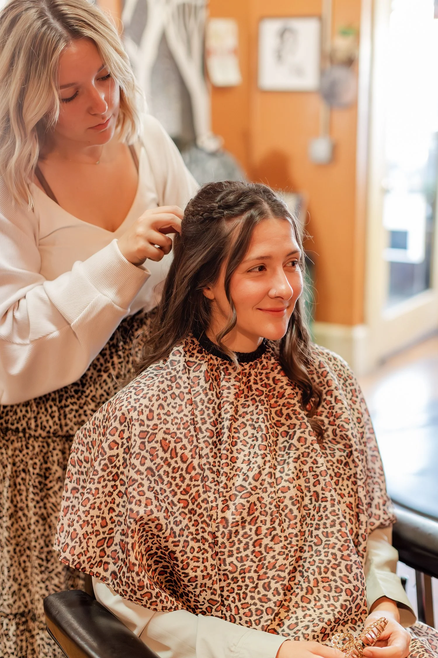 client smiling while her stylist finishes a small braid, Hair, Heart and Soul, brand photography session, Bolivar MO