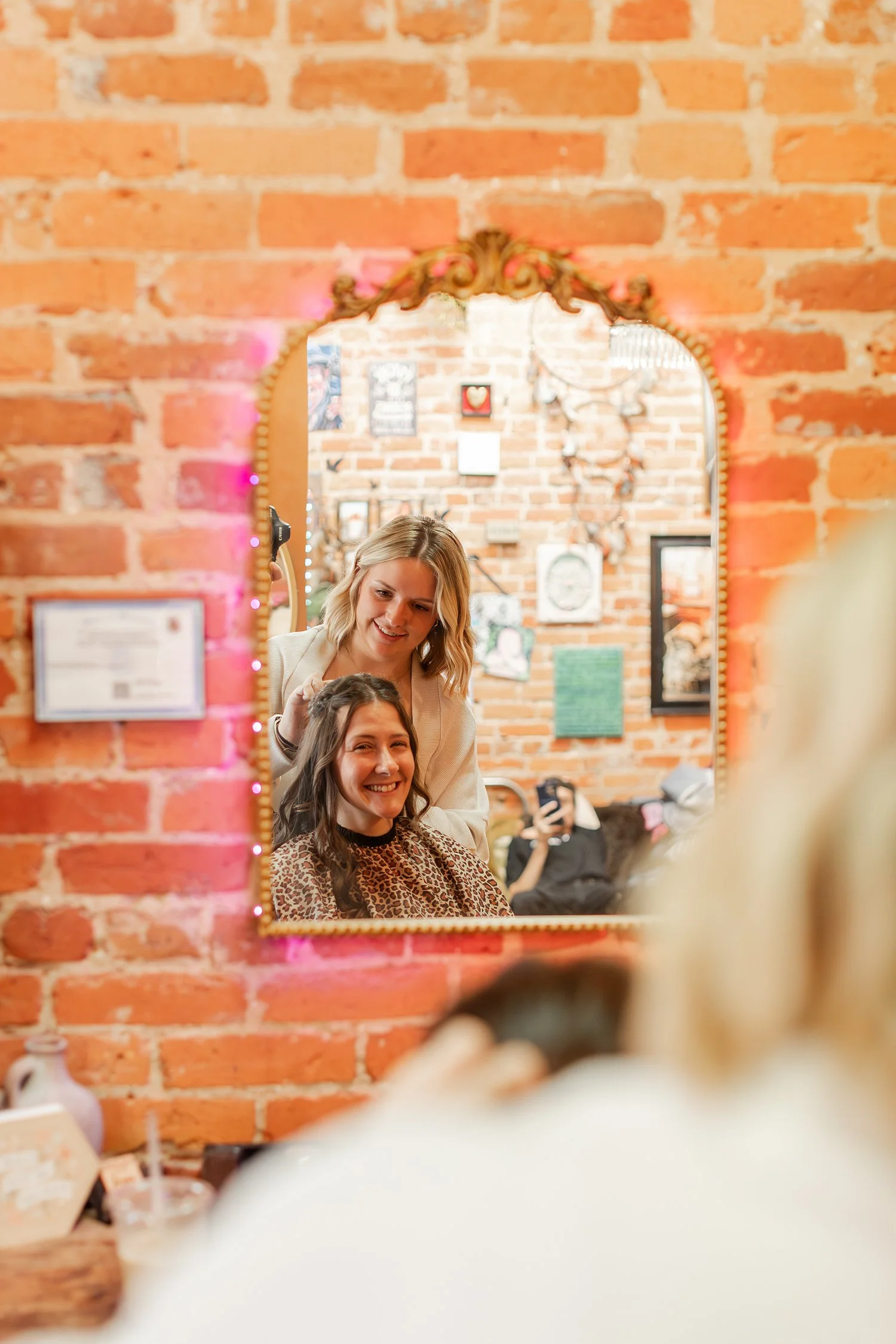 stylist and client reflected in a gold-framed vintage mirror on red brick, Hair, Heart and Soul, brand photography session, Bolivar MO