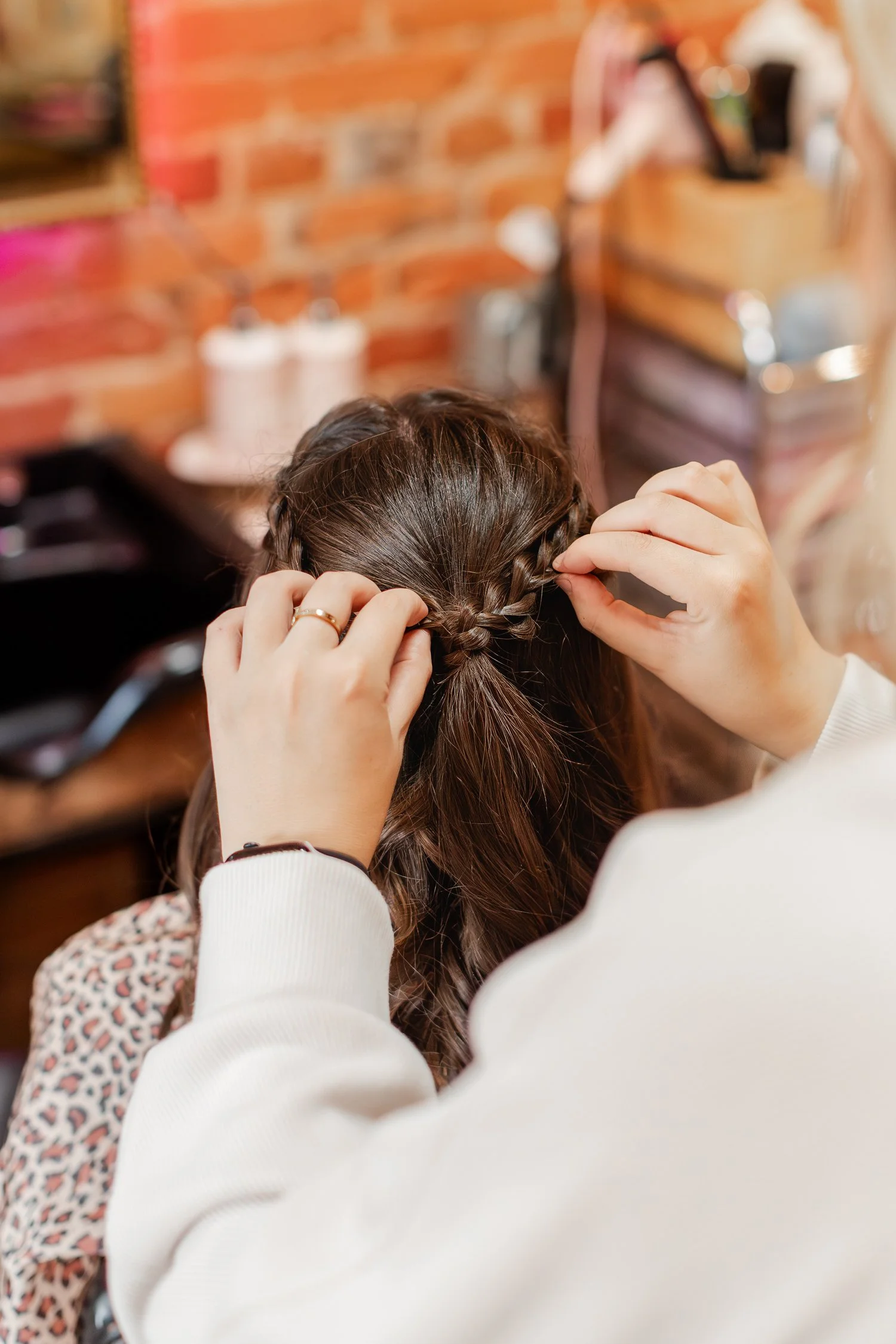 stylist pinning small braids back into a half-up style, Hair, Heart and Soul, brand photography session, Bolivar MO