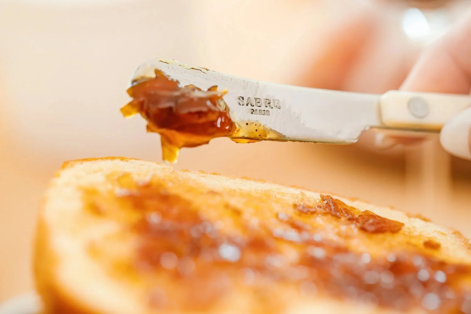A knife spreads caramel over toast in a still from Jordan Brittley’s brand video work.