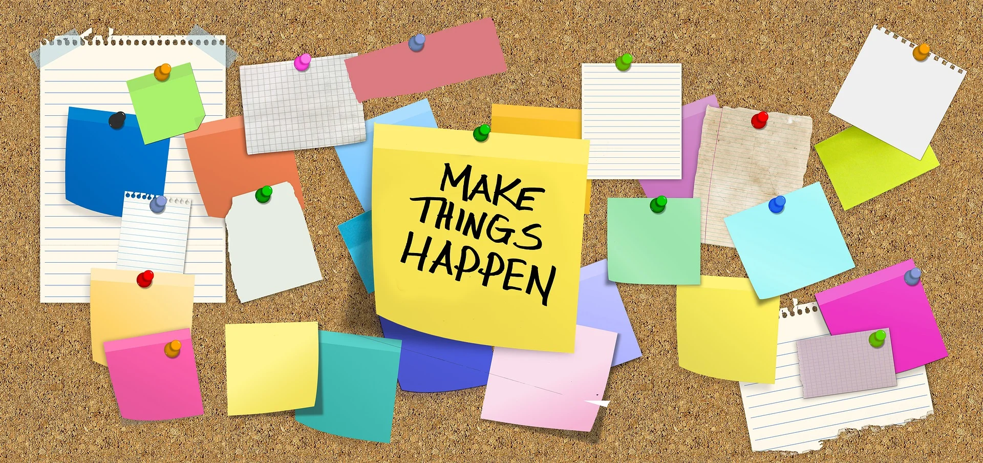 bulletin board with sign saying “make things happen”, sticky notes, and pieces of paper.