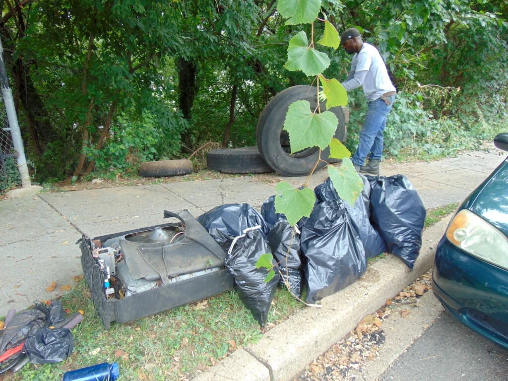 A park steward adds another tire to the day’s haul alongside a broken television and several bags of smaller trash. (Photo by Will Lennon)