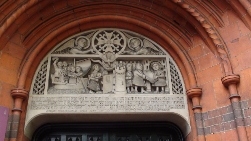 Sculpture above doorway the only remaining French Protestant Church in London, first established by royal charter in 1550 it now occupies by Aston Webb erected between 1891–93 in Soho Square.