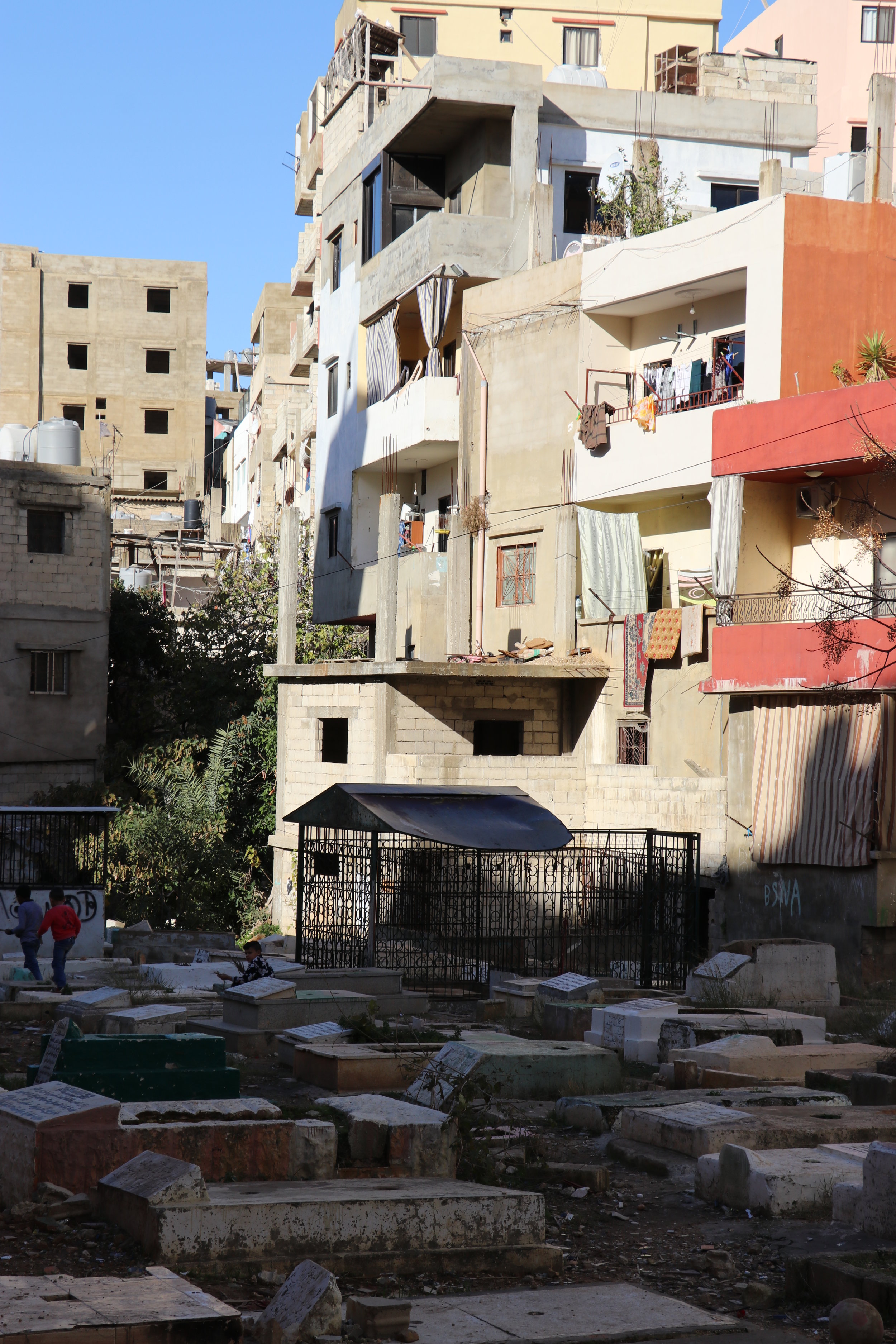 Masjid al-Quds – in the background – overlooks the cemetery, the camp’s ultimate shared space in life and death for new and established refugees. (c) E. Fiddian-Qasmiyeh. July 2016.