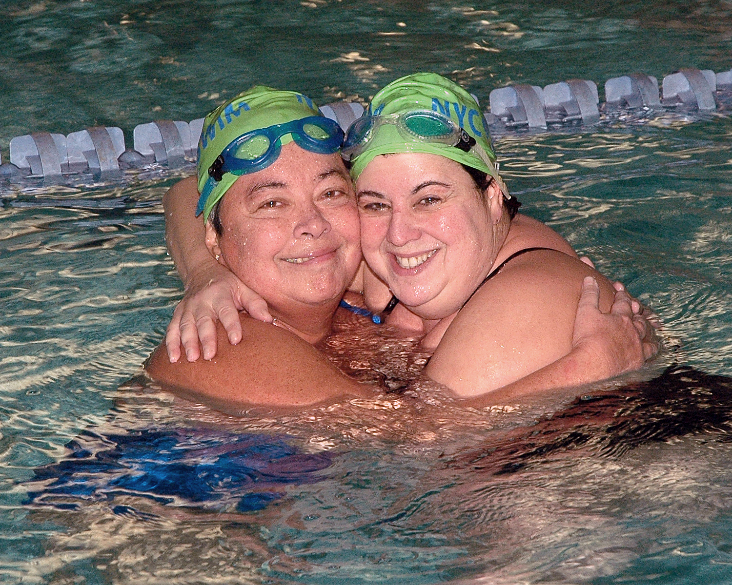 Rodolfo Chacin and Octie Cruz entering split times for their swimmers