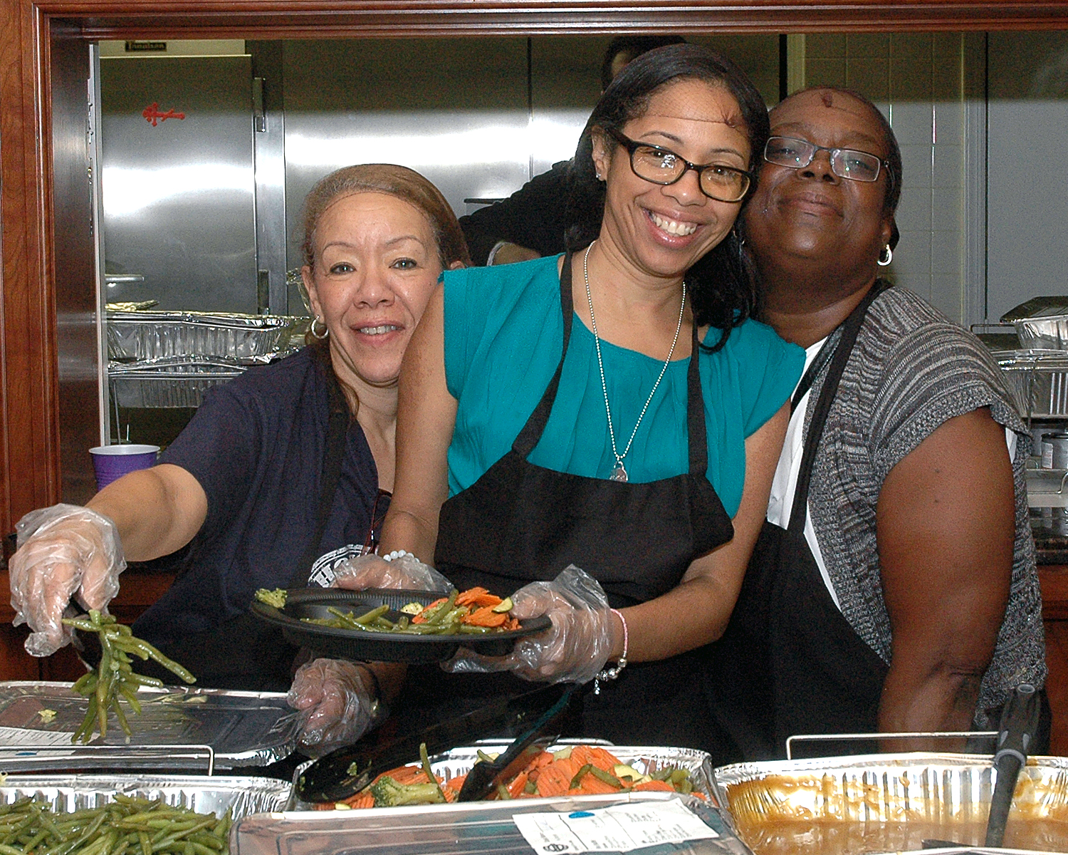 Maria Bautista, Ramona Cummings and Michelle Goree helping to serve food