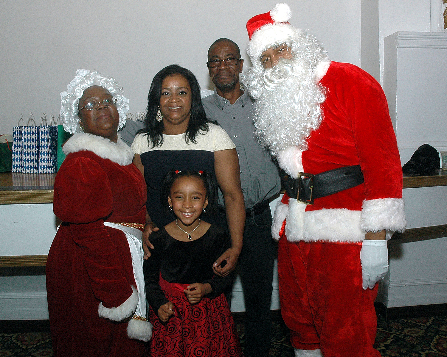 Attendees posing with Santa and Mrs. Claus