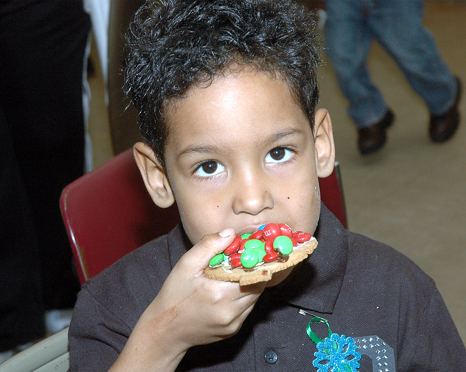 An attendee enjoying a cookie that he decorated