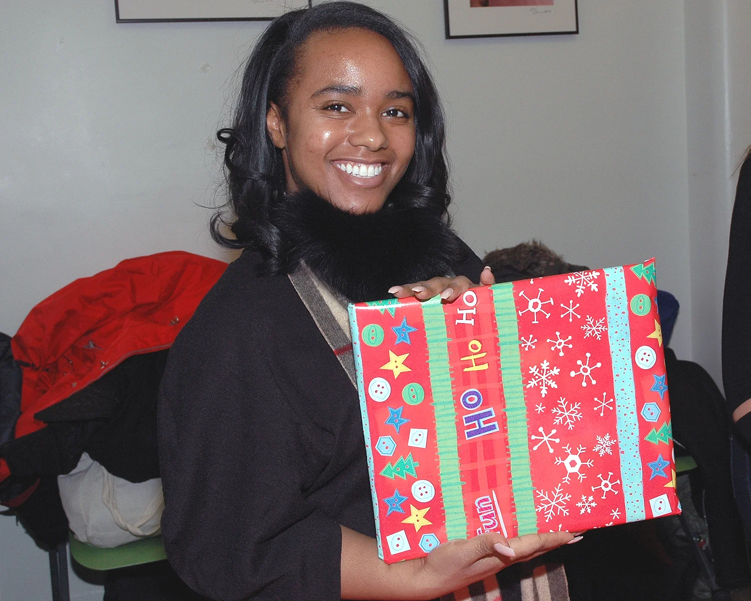 A volunteer showing the results of her gift wrapping