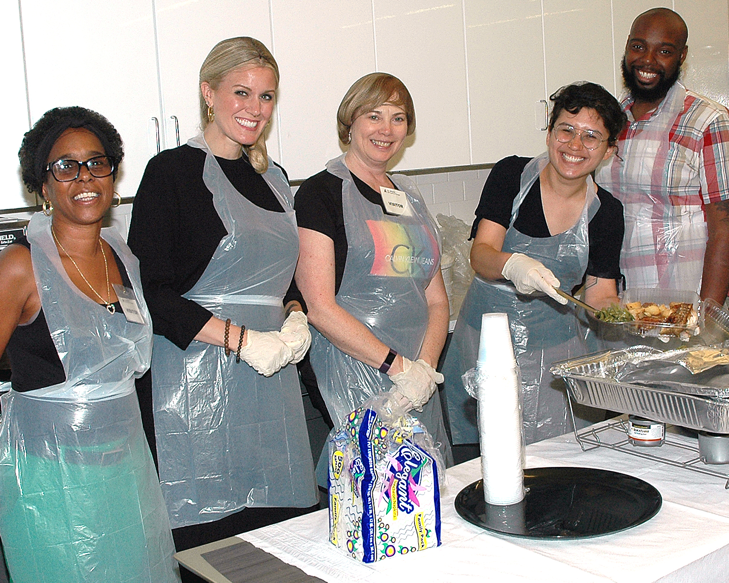 Alliance Family members Josephine and Terrence with three volunteers from PVH, Inc. getting ready to serve lunch