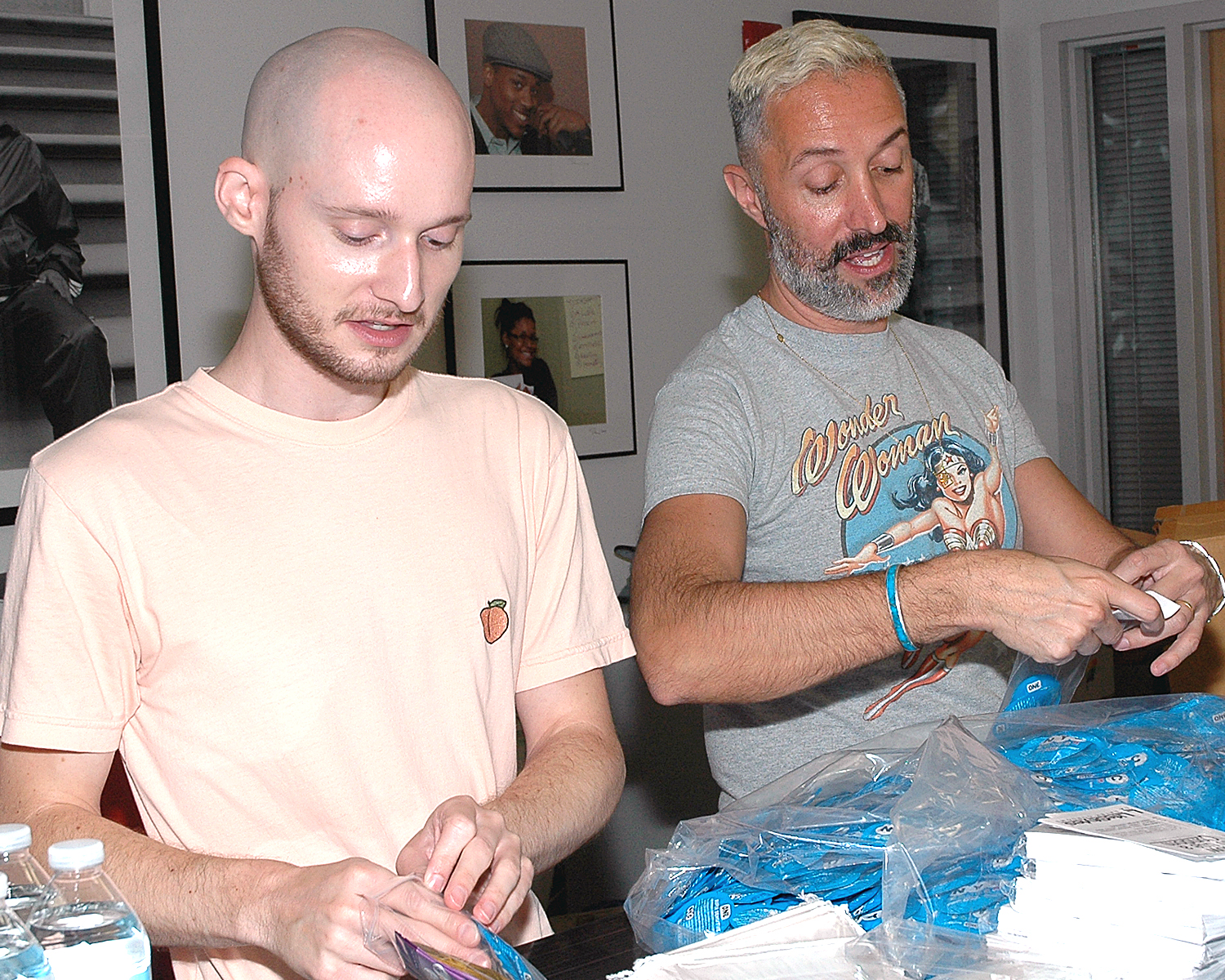 Two volunteers from PVH, Inc. assembling Safer Sex kits