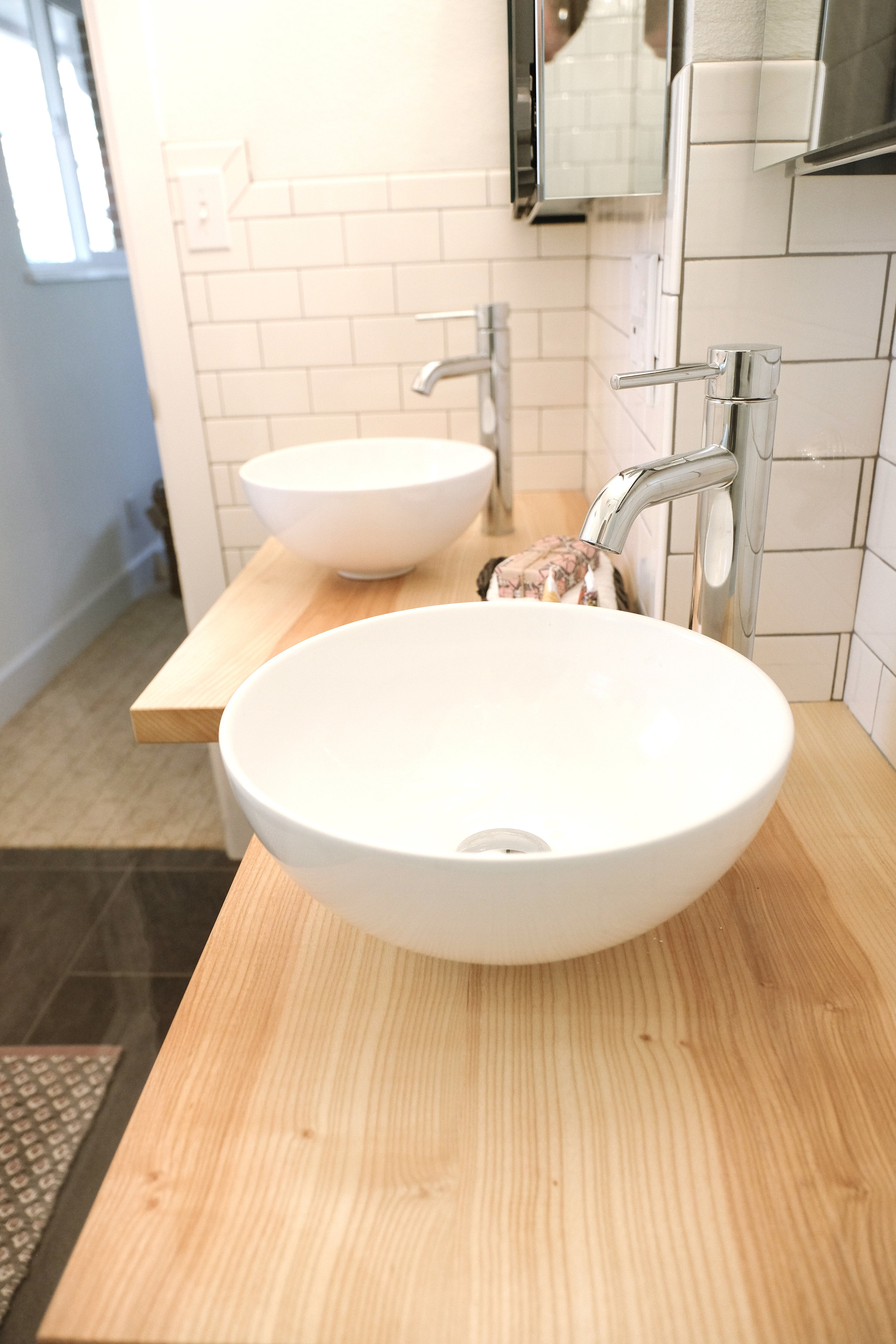 A solid ash vanity by Wild West Workshop maximizes counter space in the master bathroom. Ash was chosen for its hardness -- it's the same wood that's used for baseball bats.