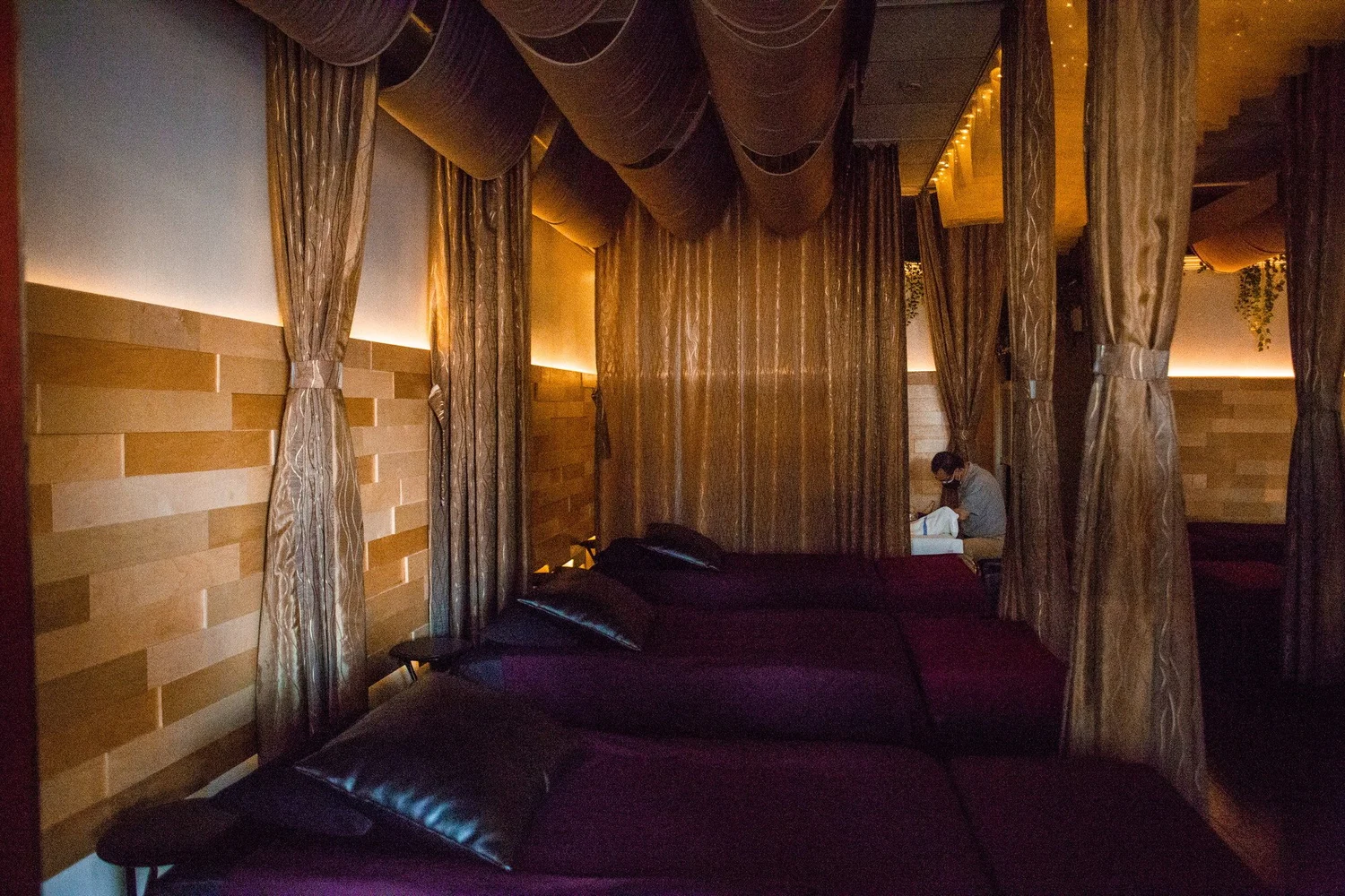 A row of curtained stations in the Reflex Lounge at Serenity Zen West Covina