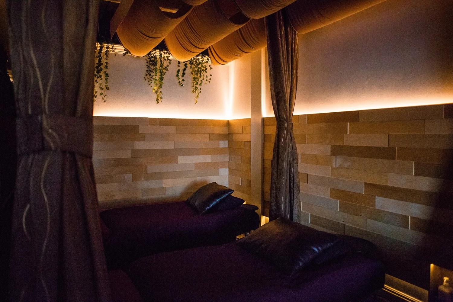 Two curtained stations in the Reflex Lounge at Serenity Zen West Covina
