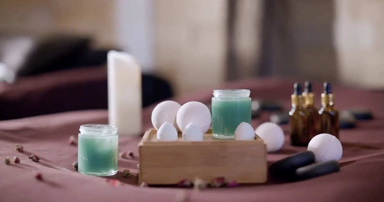 Balms, essential oils and other enhancement supplies set out on a massage table